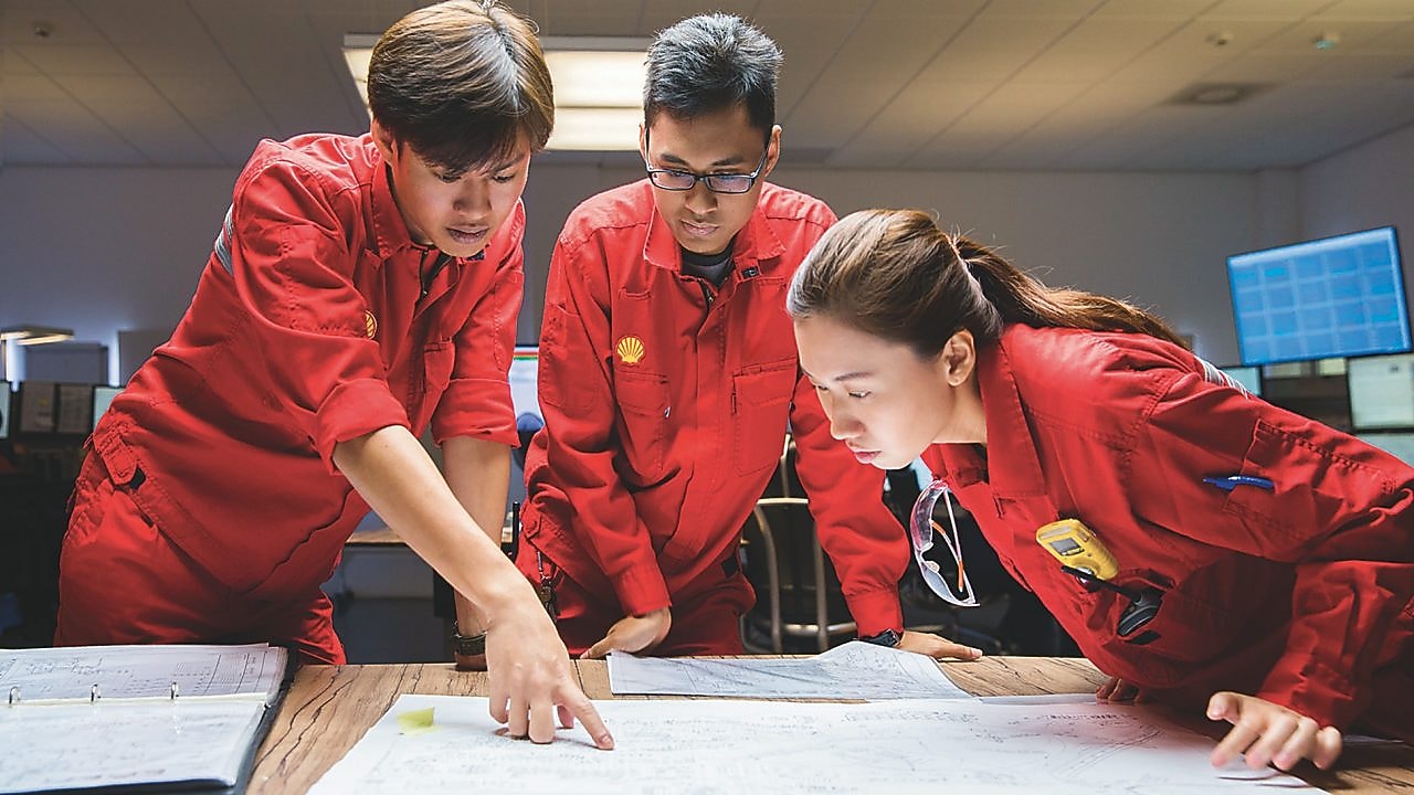 Tres empleados revisando planos