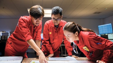 Tres empleados revisando planos