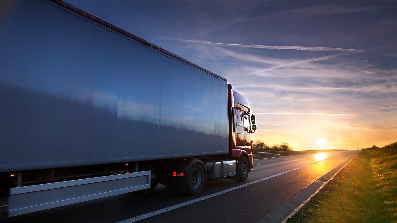 vista de camión de costado en ruta hacia el atardecer