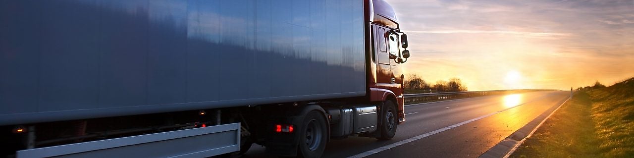 vista de camión de costado en ruta hacia el atardecer